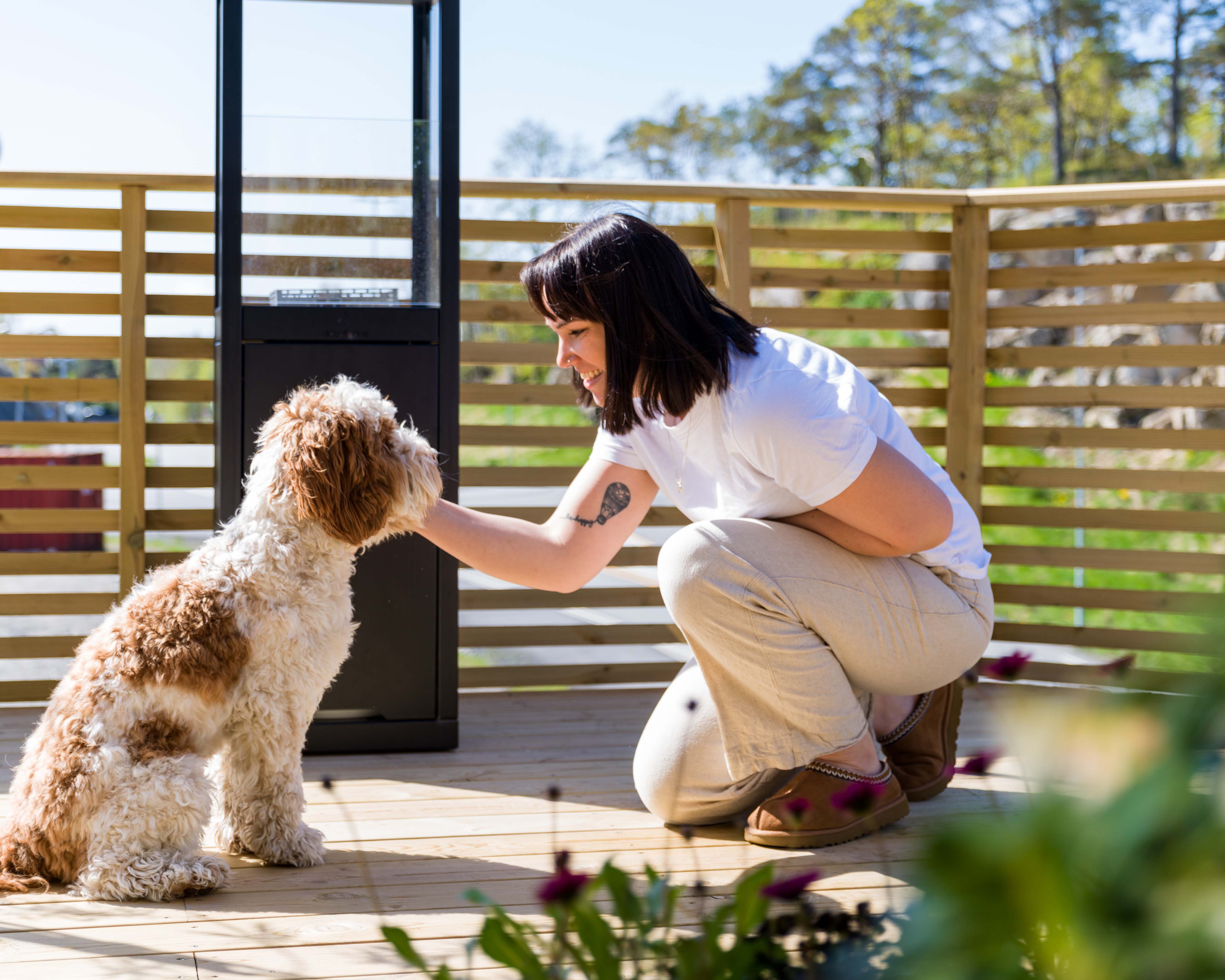 Huseier Helene med hunden Buddy på terrassen sin