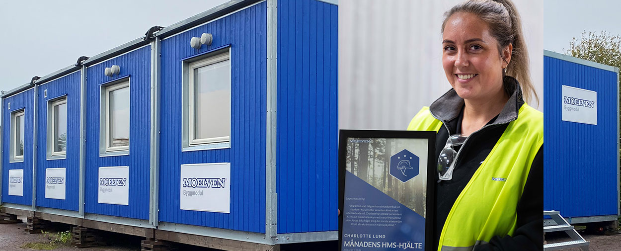 Charlotte Lund som holder en diplom for månedens HMS-helt inne i fabrikken