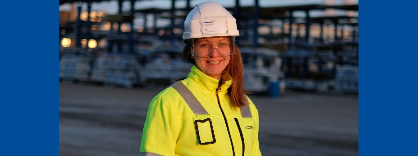 Kamila med hvit hjelp og gul sikkerhetsjakke