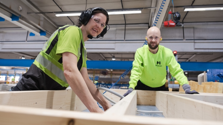 Two colleagues in a factory working together.