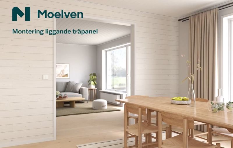 Öppen planlösnings mellan vardagsrum och matplats med ljus stående träpanel på väggarna