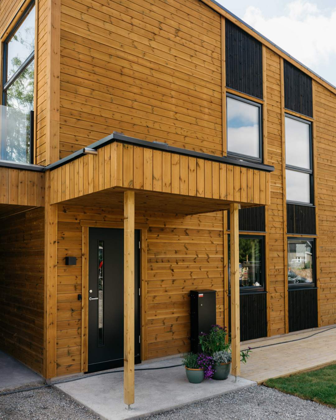 Hus med moderne transparent gulfarge på liggende kledning.