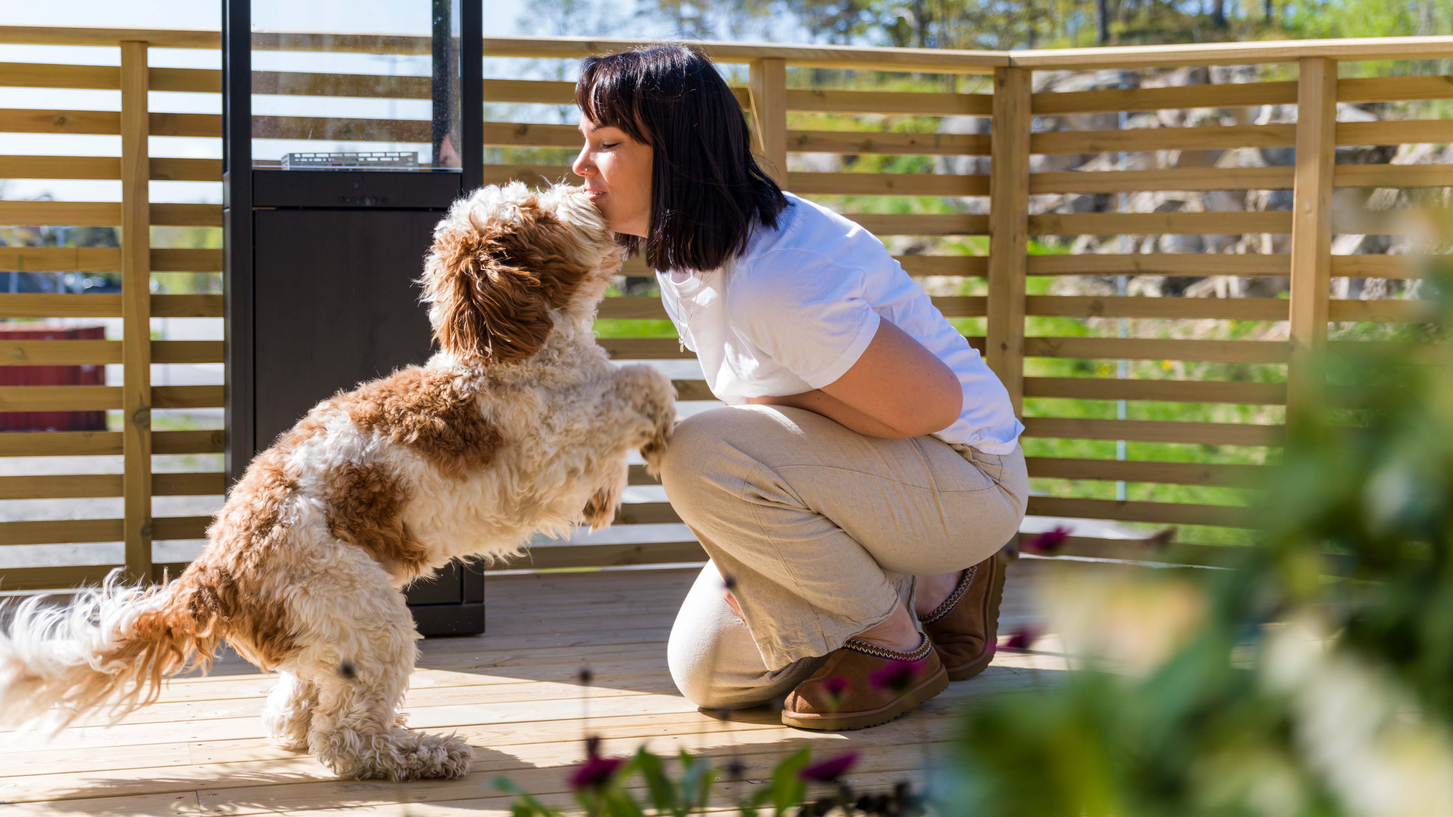 Helene, huseier med hunden Buddy på sin nybygde terrasse